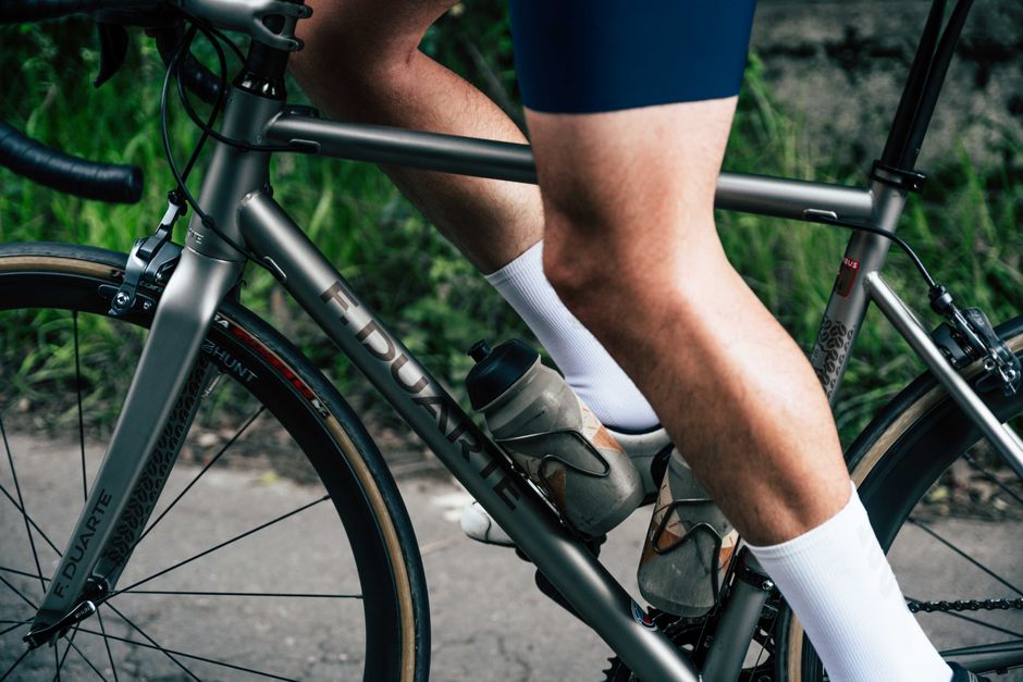 A fixed-gear rider at cadence, strapped into the pedals